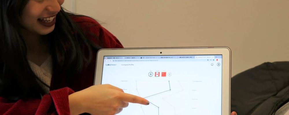 Image of people pointing at computer