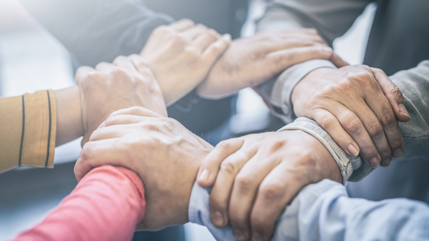 Image of 6 people holding hands in a circle