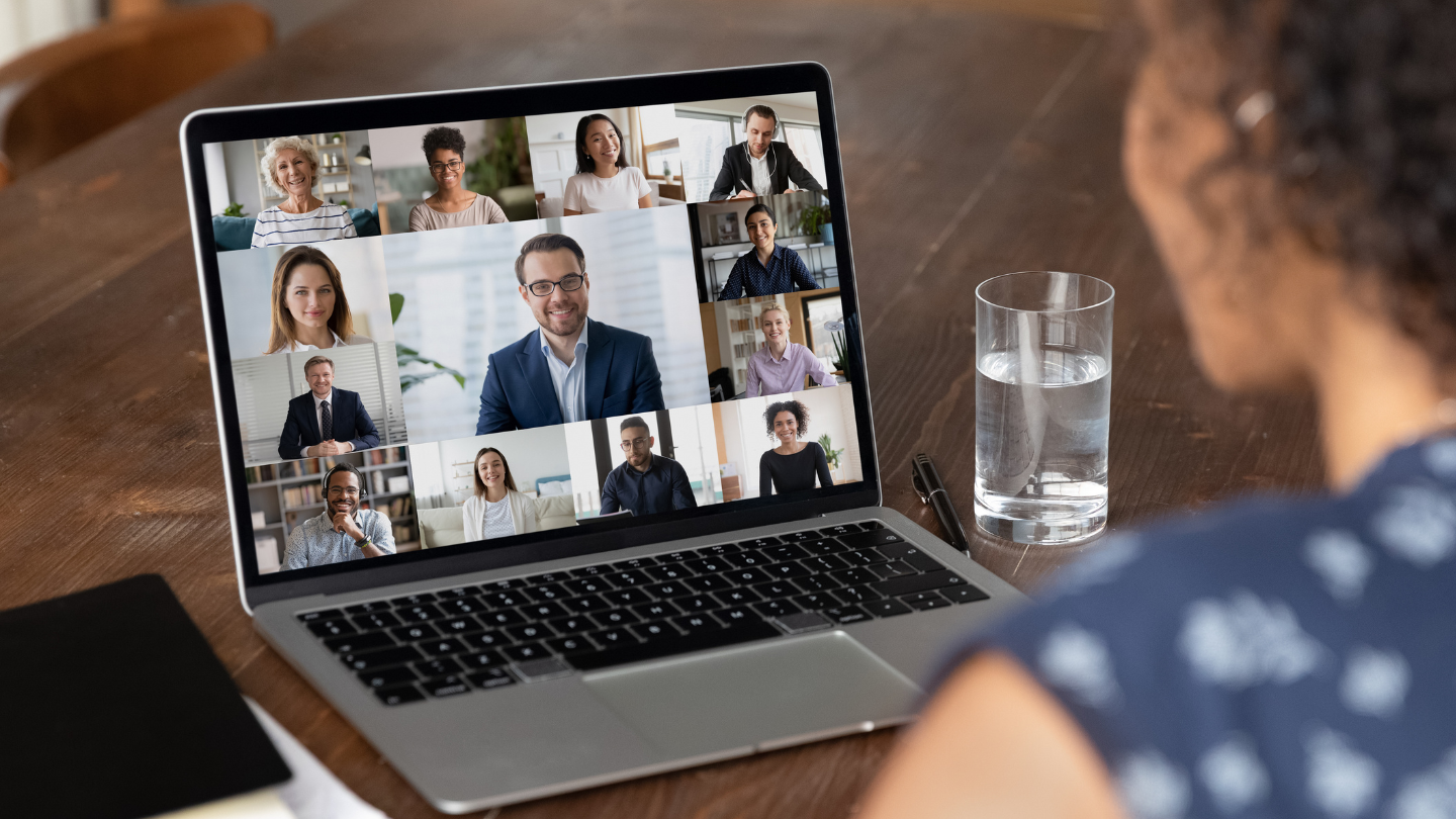 woman looking at a virtual meeting on a computer screen