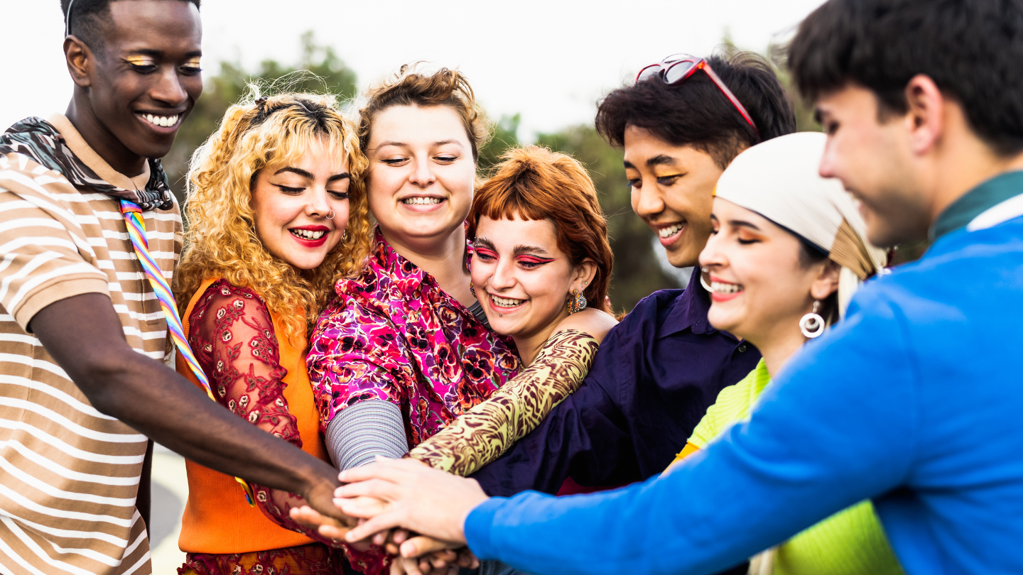 people smiling with their hands together